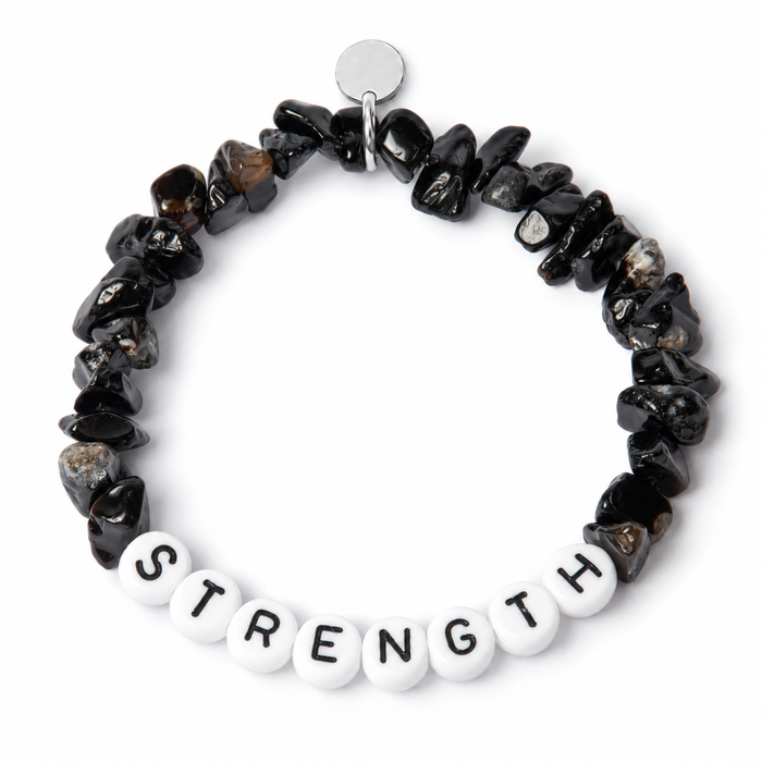 Onyx chipstone bracelet with white beads and black letters spelling STRENGTH, shown as an example personalisation, with a blank silver tag