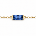 September birthstone-colour bracelet with a royal blue rectangular faceted stone and polished gold-tone chain on white.