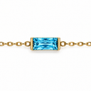 December birthstone-colour bracelet with a bright blue rectangular faceted stone and polished gold-tone chain on white.