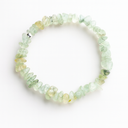 Prehnite chipstone crystal bracelet with one sterling silver bead on a white background, top-down product photo.
