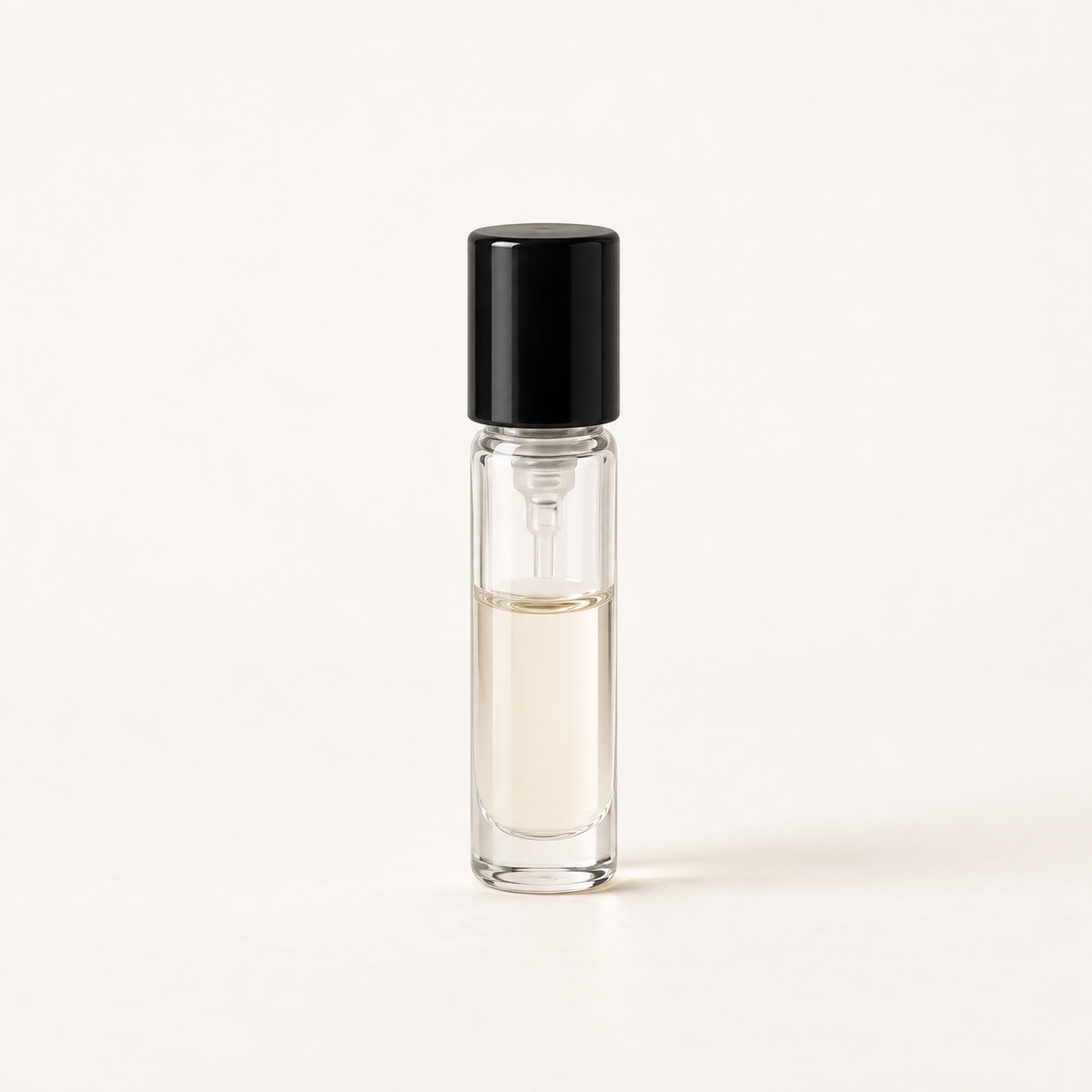 Clear perfume sample bottle with a black cap